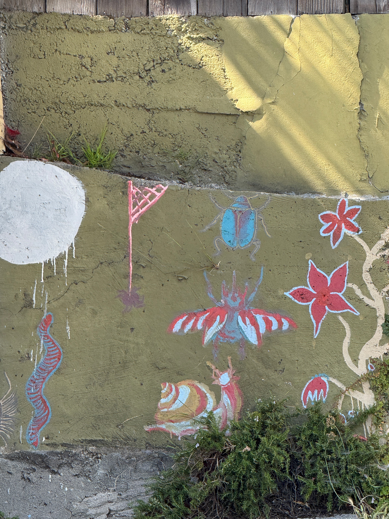 a wall pained with insects snails and a stylized plant