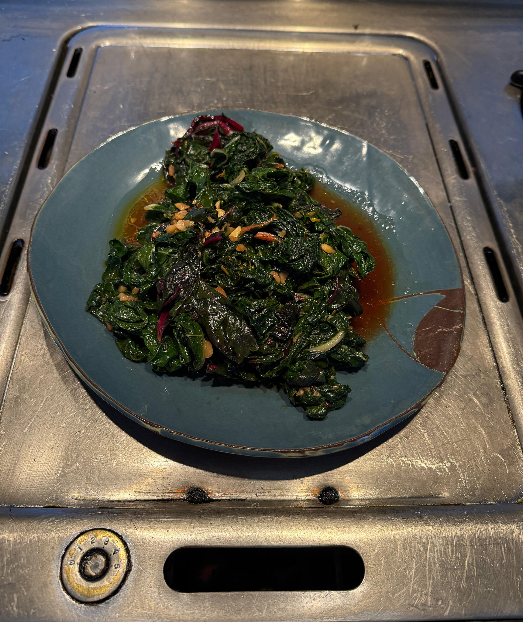 Cooked chard on a blue plate